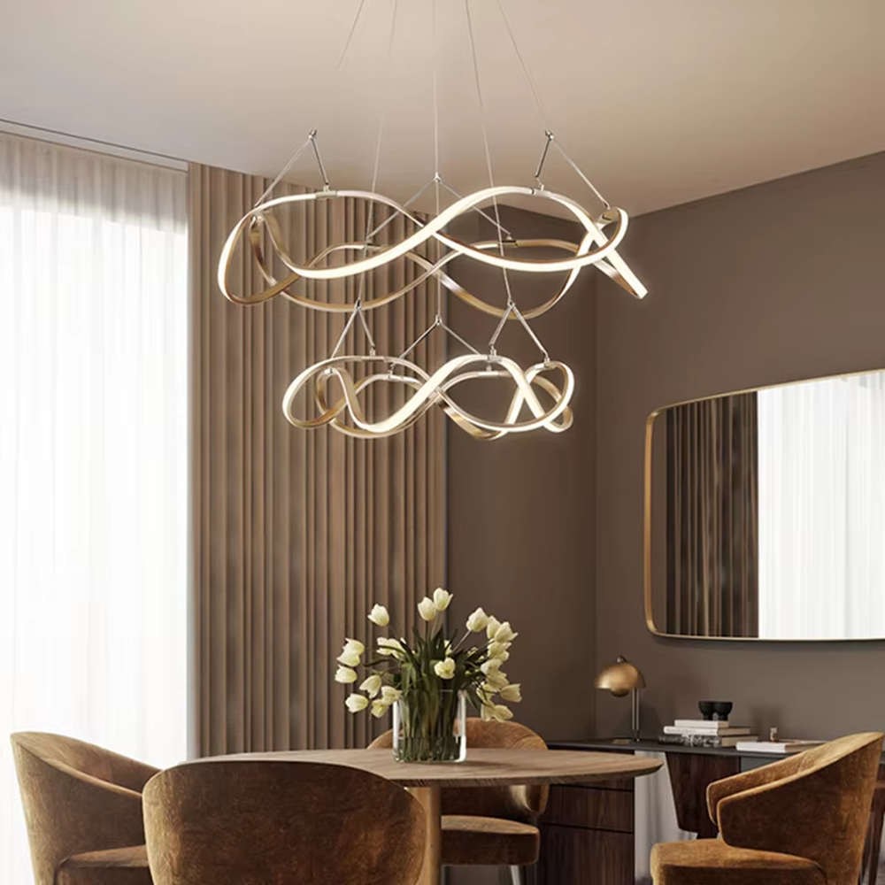 Modern art ribbon chandelier, featuring interwoven and flowing gold metal strips with built-in soft LED lighting. Its dynamic and layered lines combine artistry and ambiance, making it a high-end decorative lighting fixture that elevates the space's style.