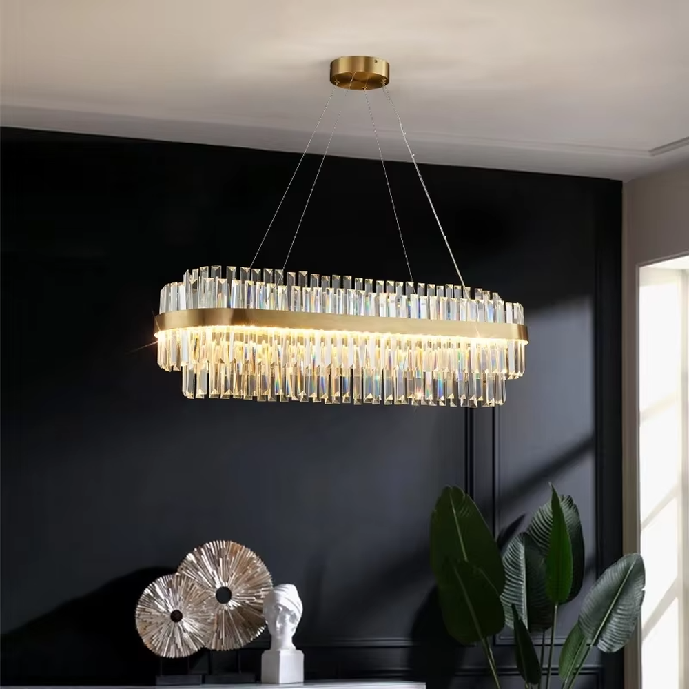 This modern light luxury two-layer circular crystal chandelier features a gold metal frame, with dense transparent long crystals hanging down to form a full circular shape. When lit, light refracts through the crystal to emit a brilliant and soft glow, combining a luxurious texture with an ambient atmosphere. Ideal for dining rooms, living rooms, light luxury apartments, and other spaces, it adds an exquisite and sophisticated touch to modern minimalist or light luxury home environments.