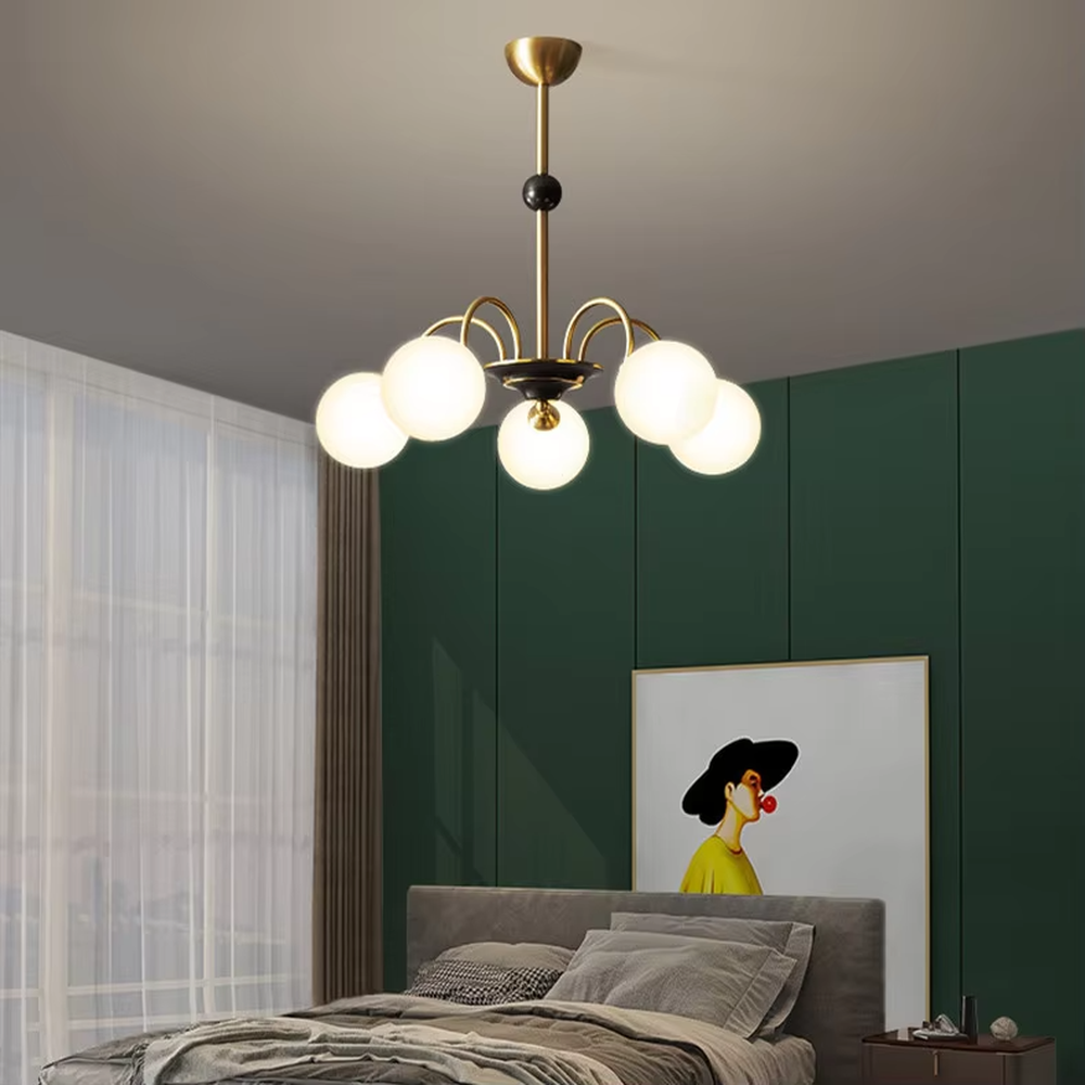 Modern light luxury black and gold magic bean chandelier, featuring curved brackets in black and gold metal paired with milk-white frosted glass ball lampshades. Its rounded, soft, and layered design combines warmth and style, making it a decorative lighting fixture that enhances the space's texture.