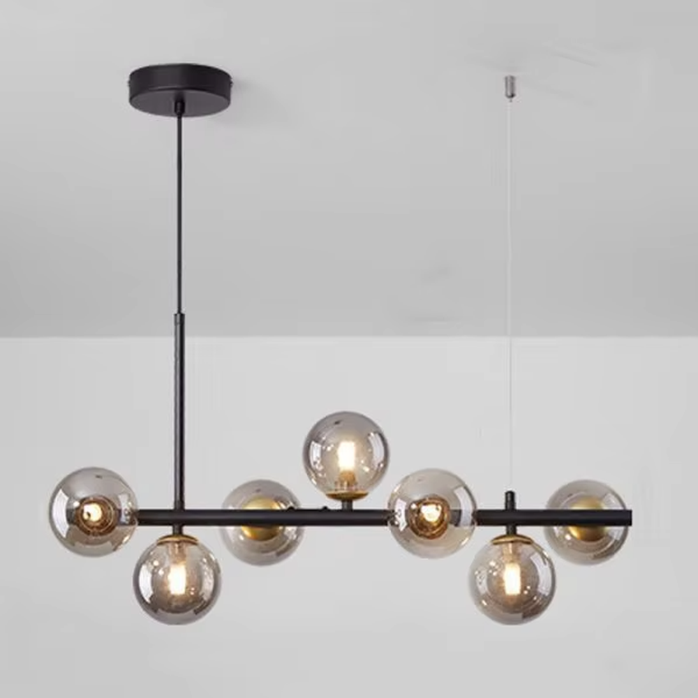 Modern light luxury molecular structure chandelier, featuring a linear brass metal frame paired with gradient smoky gray glass ball lampshades. Its minimalist and layered design combines style and ambiance, making it a decorative lighting fixture that elevates the space's aesthetic.
