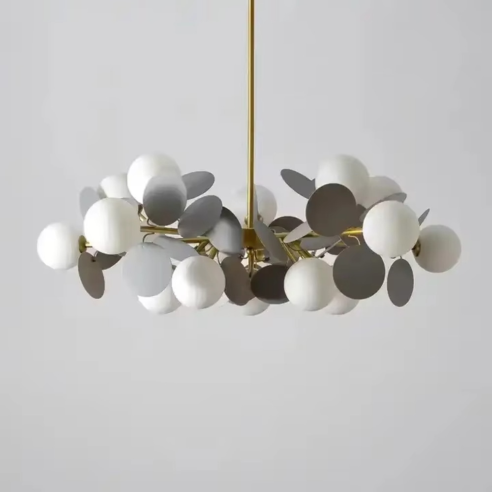 Modern light luxury firefly chandelier, featuring a radial branch frame in brass metal paired with clustered milk-white frosted glass balls to form a starburst shape. It emits soft and translucent light, combining a dreamy feel and elegant ambiance, making it a high-end decorative lighting fixture that elevates the space's style.