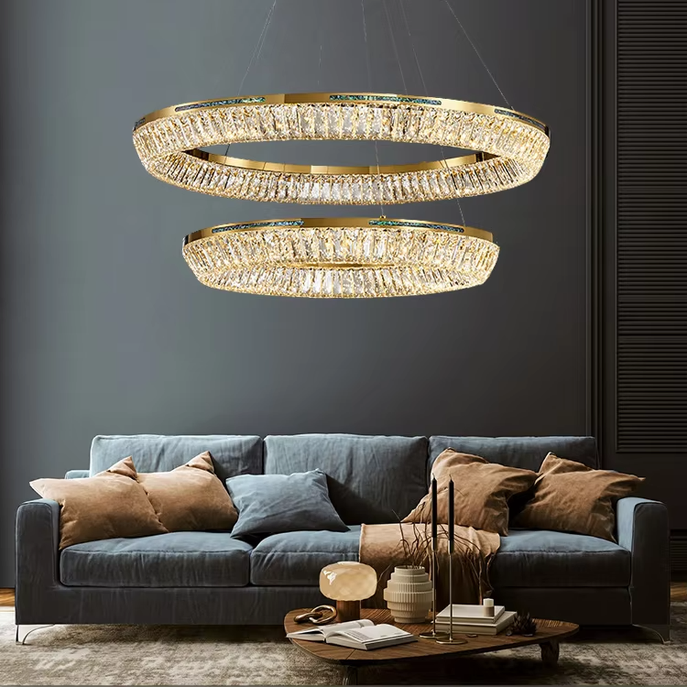 This modern light luxury rectangular two-layer crystal chandelier features a gold metal frame, inlaid with transparent long crystals to form a double-layered rectangular shape. When lit, light refracts through the crystal to emit a brilliant and soft glow, combining an exquisite texture with an ambient atmosphere. Ideal for dining rooms, bars, and above dining tables in light luxury apartments, it adds an exquisite and sophisticated touch to modern minimalist or light luxury spaces.