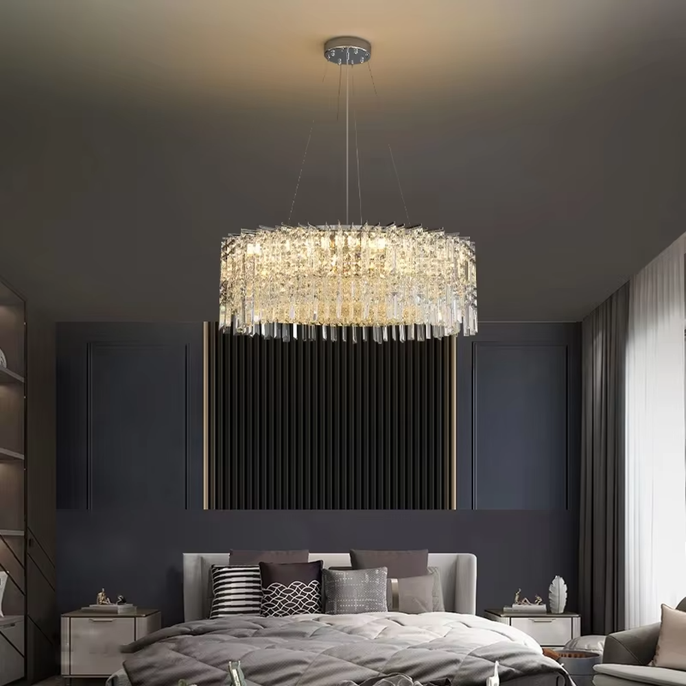 This modern light luxury square crystal chandelier features a silver metal frame, with dense transparent long crystals hanging down to form a square shape. When lit, light refracts through the crystal to emit a brilliant and soft glow, combining an exquisite texture with an ambient atmosphere. Ideal for bedrooms, dining rooms, light luxury apartments, and other spaces, it adds an exquisite and sophisticated touch to modern minimalist or light luxury home environments.