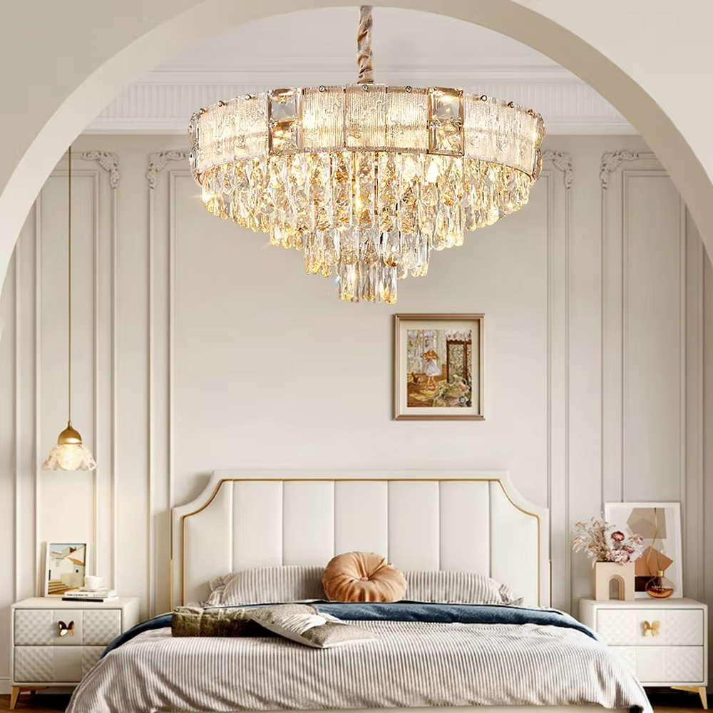 This light luxury and grand two-layer crystal chandelier features a gold metal frame with vertical-textured glass lampshades on the upper layer, and multiple layers of transparent crystal tassels hanging below, creating a full dome shape. When lit, light refracts through the crystal to emit a brilliant and soft glow, combining elegant texture with an ambient atmosphere. Ideal for bedrooms, living rooms, dining rooms, and other spaces, it adds an elegant and exquisite touch to European light luxury or modern minimalist home environments.
