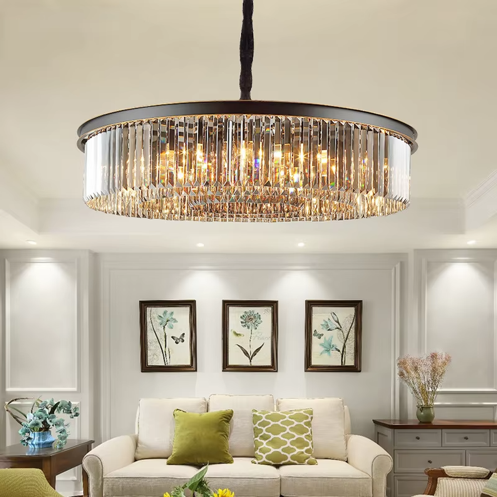 This modern light luxury circular crystal chandelier features a black metal frame, with dense transparent long crystals hanging down to form a full circular shape, suspended by a braided cord. When lit, light refracts through the crystal to emit a brilliant and soft glow, combining a bold texture with an ambient atmosphere. Ideal for living rooms, dining rooms, light luxury apartments, and other spaces, it adds an exquisite and sophisticated touch to modern minimalist or light luxury home environments.