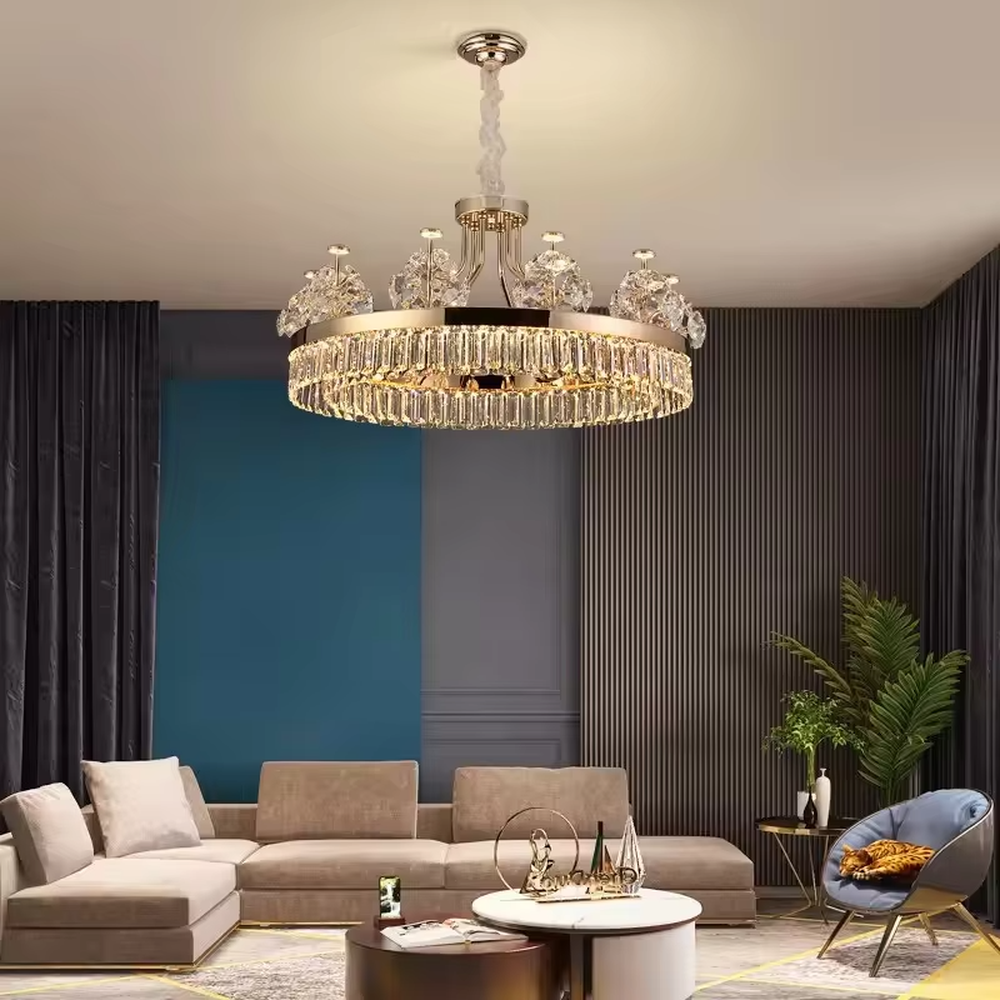 This modern light luxury two-layer crystal chandelier features a gold metal frame, with dense transparent long crystals hanging below and leaf-textured crystal lampshades on top. When lit, light refracts through the crystal to emit a brilliant and soft glow, combining an ethereal texture with an ambient atmosphere. Ideal for living rooms, dining rooms, light luxury apartments, and other spaces, it adds an exquisite and sophisticated touch to modern minimalist or light luxury home environments.