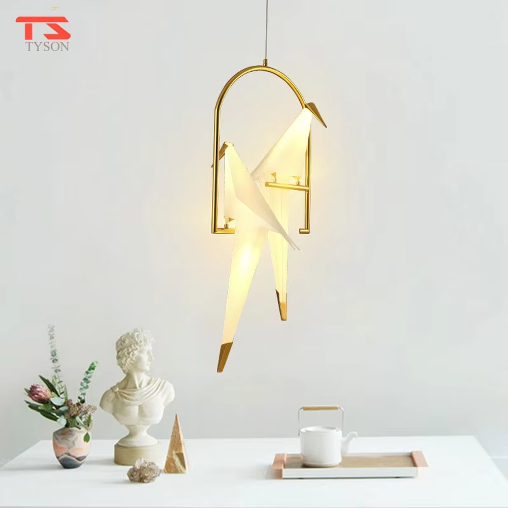 Modern art origami crane cage chandelier, featuring an arched gold metal frame paired with a white origami crane lampshade made with paper folding techniques. Its elegant and dynamic lines combine artistry and ambiance, making it a decorative lighting fixture that elevates the space's style.