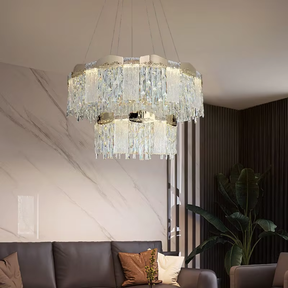This modern light luxury multi-layer crystal tassel chandelier features a gold metal frame, with multiple layers of transparent long crystal tassels hanging down to form a full square dome shape. When lit, light refracts through the crystal to emit a brilliant and soft glow, combining luxurious texture with an ambient atmosphere. Ideal for dining rooms, living rooms, light luxury apartments, and other spaces, it adds an elegant and exquisite touch to modern minimalist or light luxury home environments.