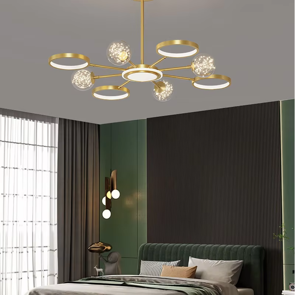 This modern light luxury radial chandelier features a gold metal frame with multiple radially extending arms, paired with glowing rings and glass ball lampshades with a starry sky effect. When lit, it emits a bright and soft glow, combining a futuristic feel with an ambient atmosphere. Ideal for living rooms, large apartments, and light luxury residences, it adds an exquisite and sophisticated touch to modern minimalist or light luxury home environments.