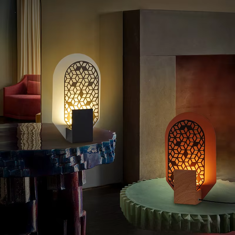 This is an artistic geometric hollow arch table lamp, with an arched hollow design (hexagonal geometric pattern), available in styles like white and orange, paired with different material bases. It features strong artistic sense, and the light forms unique light and shadow through the hollow. It is used for local desktop lighting and decoration, creating an artistic and warm atmosphere. Suitable for art exhibition halls, corners of modern home studies, designer studios and other places.
