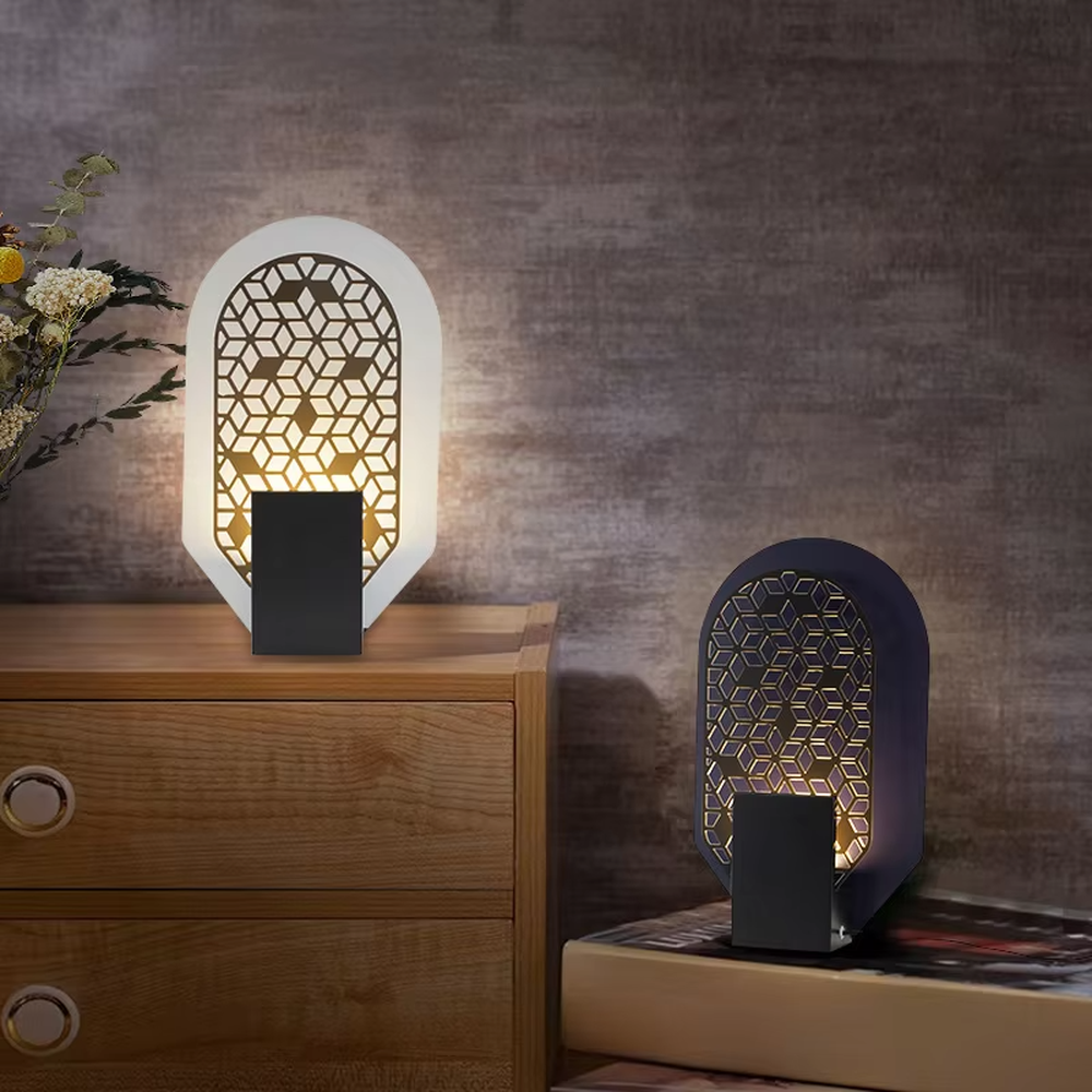 This is an artistic geometric hollow arch table lamp, with an arched hollow design (hexagonal geometric pattern), available in styles like white and orange, paired with different material bases. It features strong artistic sense, and the light forms unique light and shadow through the hollow. It is used for local desktop lighting and decoration, creating an artistic and warm atmosphere. Suitable for art exhibition halls, corners of modern home studies, designer studios and other places.