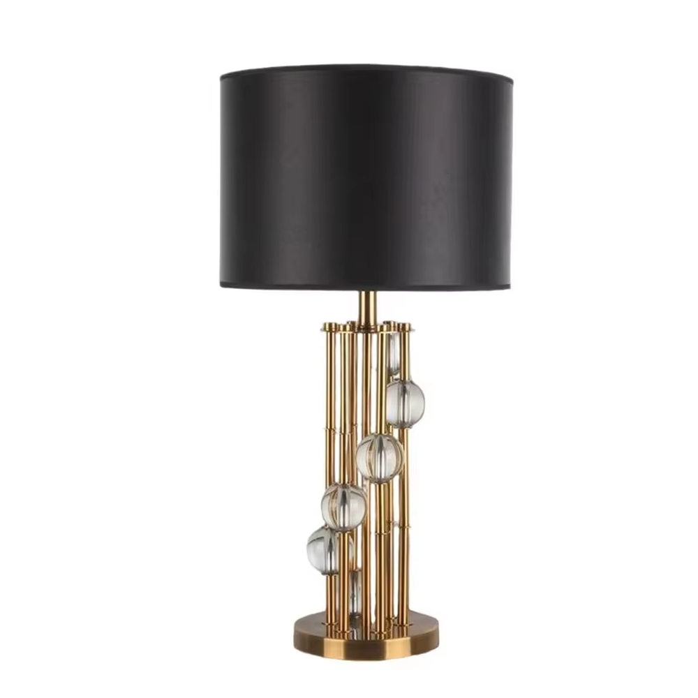 This is a luxury black-gold crystal table lamp, with a golden metal column (with multiple thin columns design) and transparent crystal balls, a black cylindrical fabric lampshade, featuring a modern luxury design with high-quality texture. It is used for local desktop lighting and decoration, creating a high-end luxury atmosphere. It is suitable for luxury-style home bedroom bedside tables, high-end hotel guest rooms, modern soft decoration display spaces and other places.