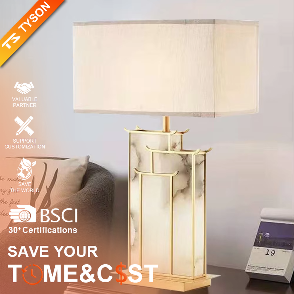 New Chinese light luxury gold frame ink texture table lamp, gold window lattice-like metal frame + ink texture panel + beige fabric lampshade, soft lighting, creating an elegant new Chinese atmosphere.