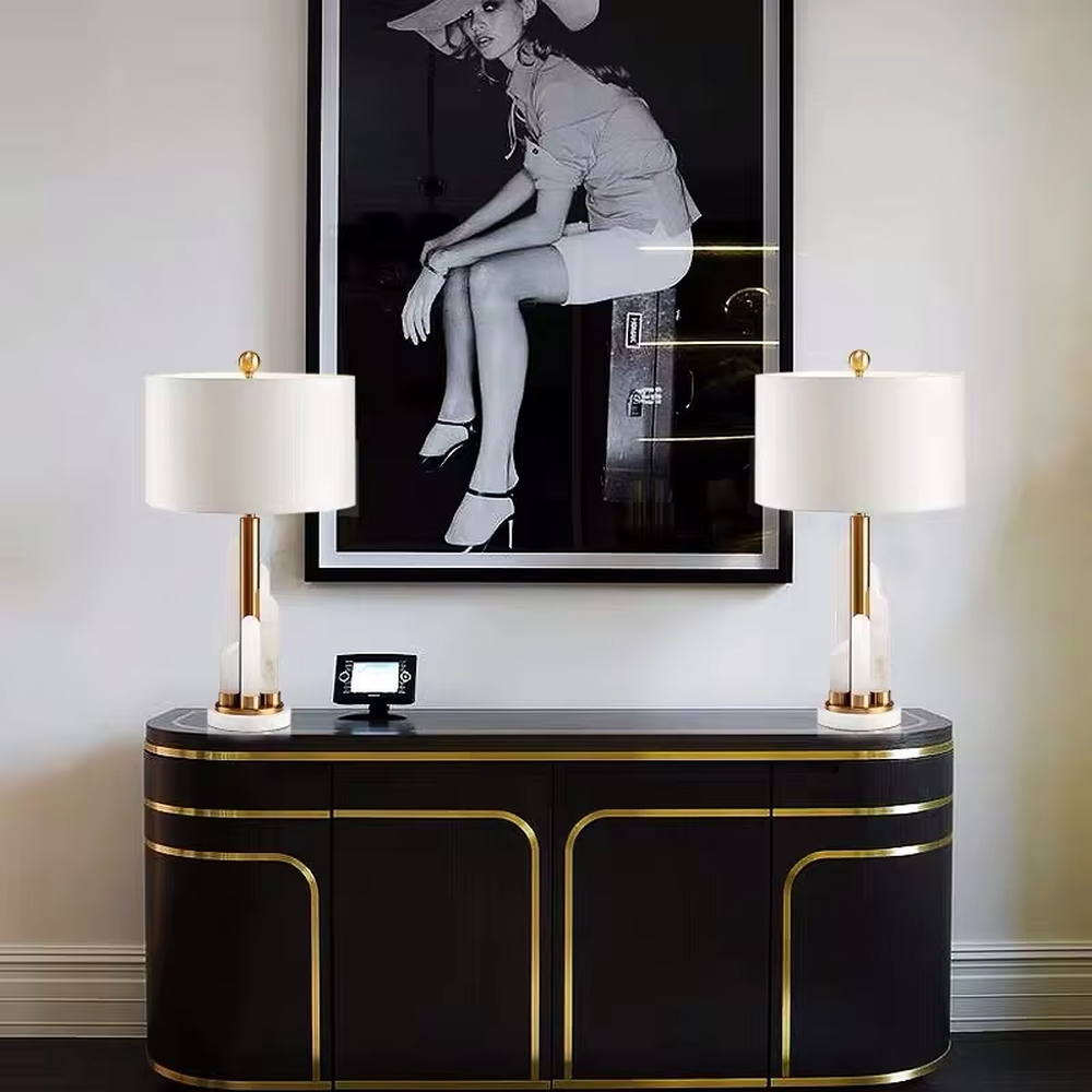Light luxury white shade gold decorative marble base table lamp, white fabric lampshade + golden metal decorations + white marble base, soft lighting, creating a high-end elegant atmosphere.