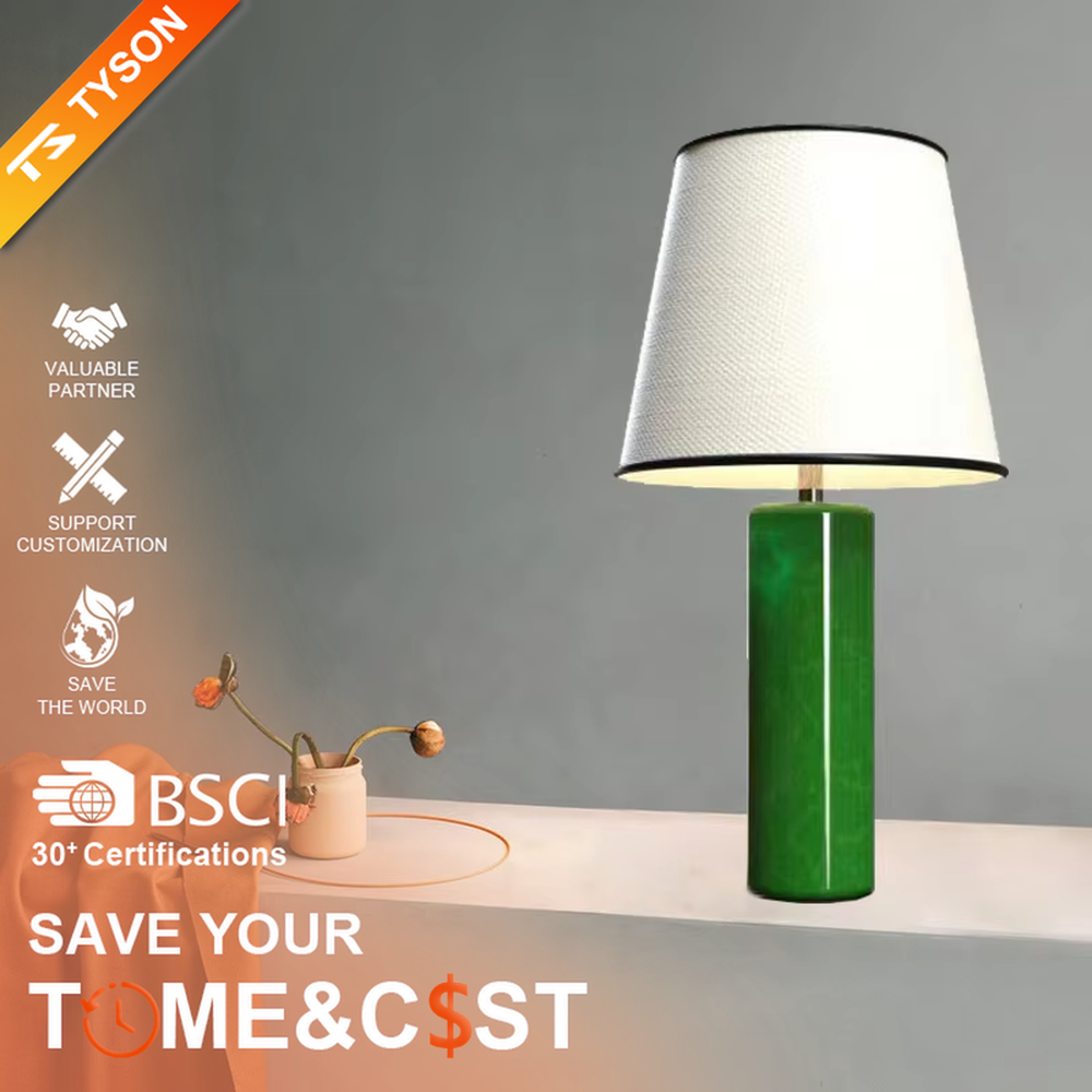 This is a modern fresh-style green cylindrical table lamp, with a green cylindrical base and a white fabric lampshade (black edging), featuring a minimalist modern design and fresh style. It is used for local desktop lighting and decoration, creating a fresh and modern atmosphere. Suitable for modern minimalist bedroom bedside tables, Nordic-style living room side tables, creative studios and other places.