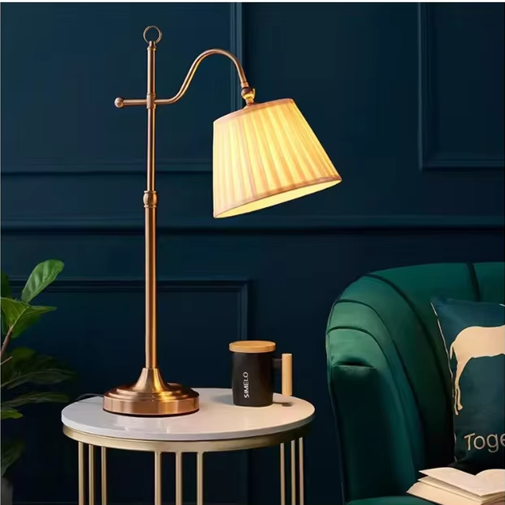 This is a retro European-style brass fabric table lamp, with a brass metal structure (with an adjustable curved arm and decorative details) and a beige pleated fabric lampshade. It features an exquisite retro design and soft warm lighting. It is used for local desktop lighting and decoration, creating a retro and warm atmosphere. Suitable for European-style bedrooms, studies, retro-style living rooms and other places.