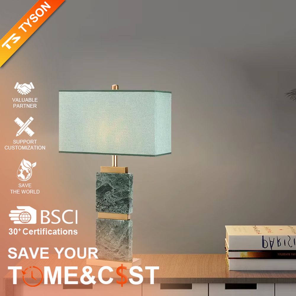 Light luxury dark green marble gold-decor light cyan fabric lampshade table lamp, square marble base + golden decorative strips + light cyan fabric lampshade, soft light, creating a high-end light luxury atmosphere.