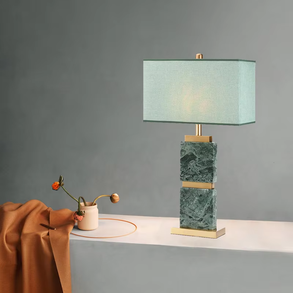 Light luxury white veined stone gold-decor rectangular fabric lampshade table lamp, white veined stone main body + golden metal decoration + white fabric lampshade, soft light, creating a high-end light luxury atmosphere.