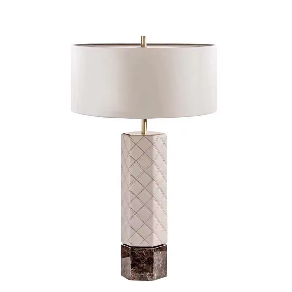 This is a light luxury elegant-style geometric textured column table lamp, with a beige fabric round lampshade, paired with golden metal connectors and a geometric textured column (marble texture at the bottom). It features an exquisite light luxury design, with warm and soft lighting. It is used for local desktop lighting and decoration, creating a light luxury elegant atmosphere. Suitable for light luxury-style bedroom bedside tables, modern minimalist living room side tables, high-end hotel guest rooms and other places.