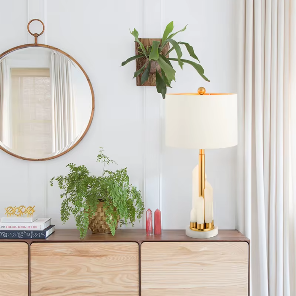 Light luxury white shade gold decorative marble base table lamp, white fabric lampshade + golden metal decorations + white marble base, soft lighting, creating a high-end elegant atmosphere.