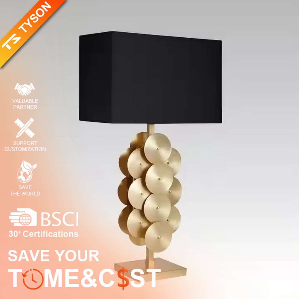 This is a luxury-style black and gold table lamp, with a golden disc-stacked base and a black square fabric lampshade, featuring a minimalist and grand design with strong luxury texture. It is used for local desktop lighting and decoration, creating a luxury and modern atmosphere. It is suitable for luxury-style home bedroom bedside tables, high-end hotel guest rooms, modern minimalist living room side tables and other places.