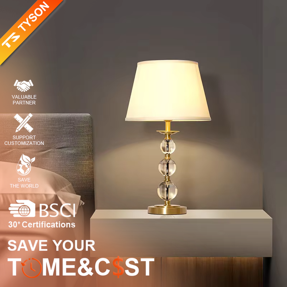 This is a light luxury exquisite crystal ball column table lamp, with a golden metal base and connectors, paired with transparent crystal ball columns and a beige fabric lampshade. It features a light luxury and exquisite design, with warm and soft lighting. It is used for local desktop lighting and decoration, creating a light luxury elegant atmosphere. Suitable for light luxury-style bedroom bedside tables, modern minimalist living room side tables, high-end hotel guest rooms and other places.