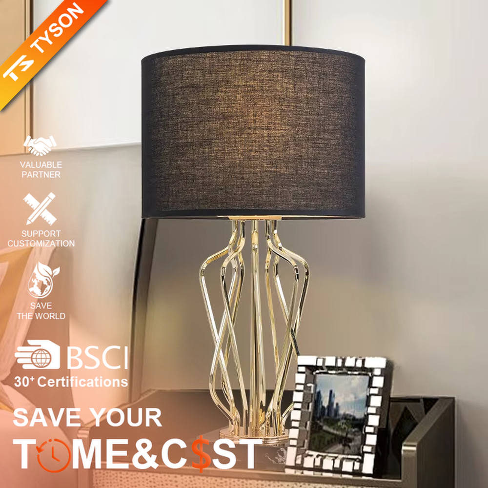 Light luxury golden interlaced hollow table lamp, white cylindrical fabric lampshade + black base, soft and warm lighting, creating a high-end elegant atmosphere.