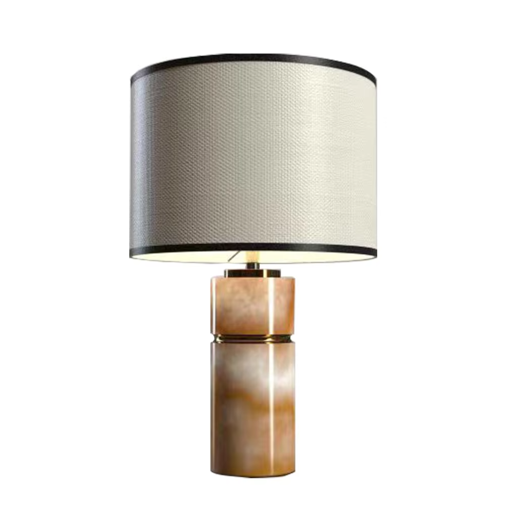 This is a light luxury minimalist table lamp, with a beige textured fabric lampshade (embellished with black trim) paired with a copper-gold layered texture base. It has an elegant and high-end style, with soft and warm lighting, creating a light luxury minimalist atmosphere.