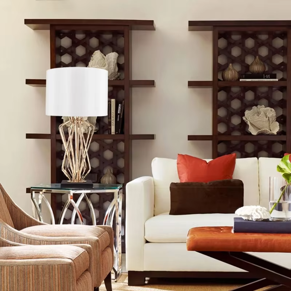 Light luxury golden interlaced hollow table lamp, white cylindrical fabric lampshade + black base, soft and warm lighting, creating a high-end elegant atmosphere.