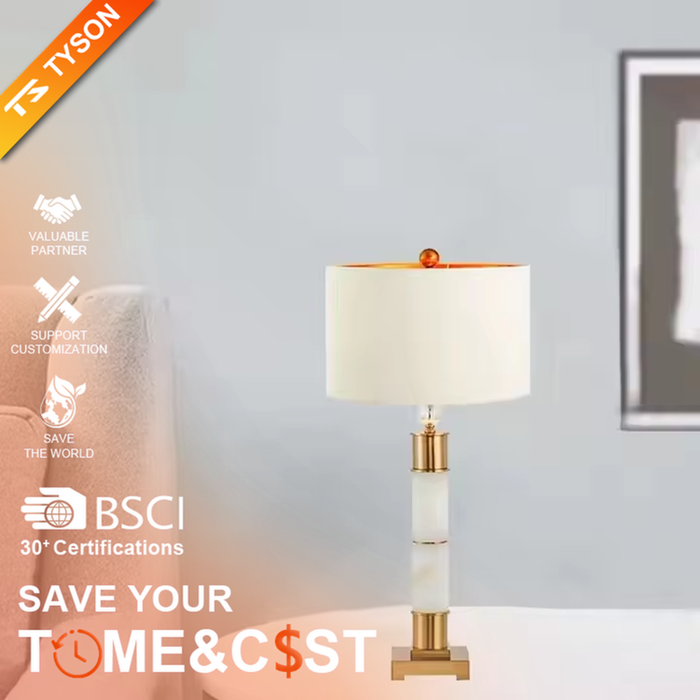 This is a luxury-style gold and white table lamp, combining golden metal and white cylinder, with a beige fabric circular lampshade, featuring a minimalist and grand design with strong luxury texture. It is used for local desktop lighting and decoration, creating a luxury and warm atmosphere. It is suitable for luxury-style home bedroom bedside tables, high-end hotel guest rooms, modern minimalist living room side tables and other places.
