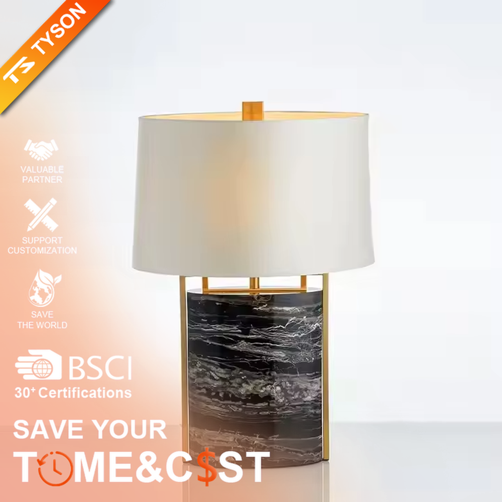This is a luxury marble table lamp, with a black-veined marble base, a golden metal frame, and a white cylindrical fabric lampshade, featuring a minimalist luxury design with strong modern texture. It is used for local desktop lighting and decoration, creating a high-end luxury atmosphere. It is suitable for luxury-style home bedroom bedside tables, high-end hotel guest rooms, modern soft decoration display spaces and other places.