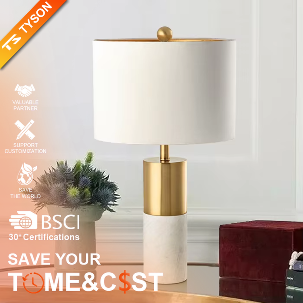 Light luxury gold-decor white marble cylindrical base table lamp, beige fabric cylindrical lampshade, soft warm light, creating a simple high-end light luxury atmosphere.