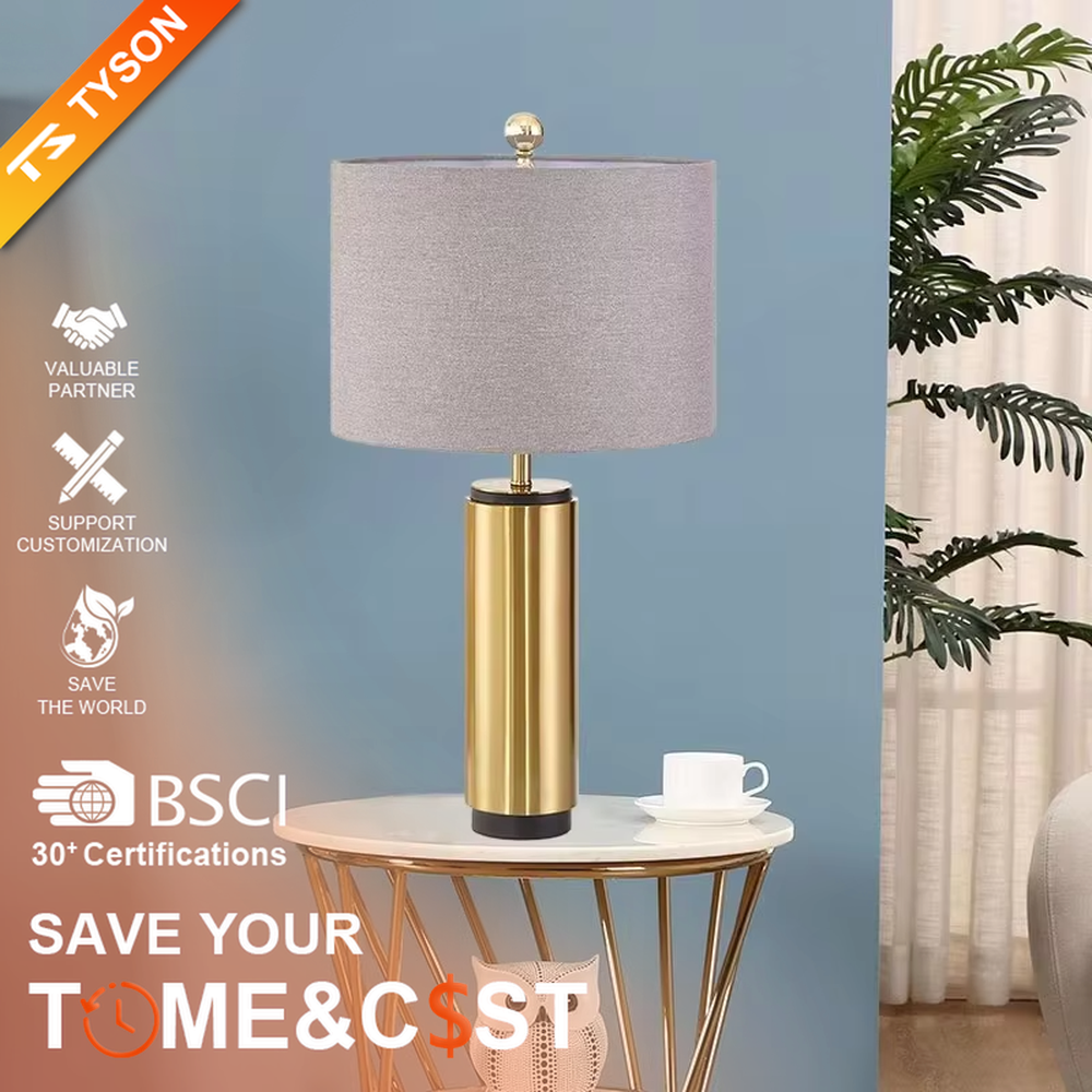 This is a luxury-style gold and gray table lamp, with a golden cylindrical base and a gray fabric circular lampshade, featuring a minimalist and grand design with strong luxury texture. It is used for local desktop lighting and decoration, creating a luxury and modern atmosphere. It is suitable for luxury-style home bedroom bedside tables, high-end hotel guest rooms, modern minimalist living room side tables and other places.