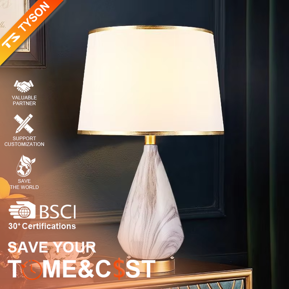 This is a light luxury marble-patterned cone table lamp, with a white fabric lampshade paired with a black-gray-white textured cone base, decorated with a golden metal base at the bottom and a small golden ball at the top. The lighting is soft and warm, creating an elegant light luxury atmosphere.