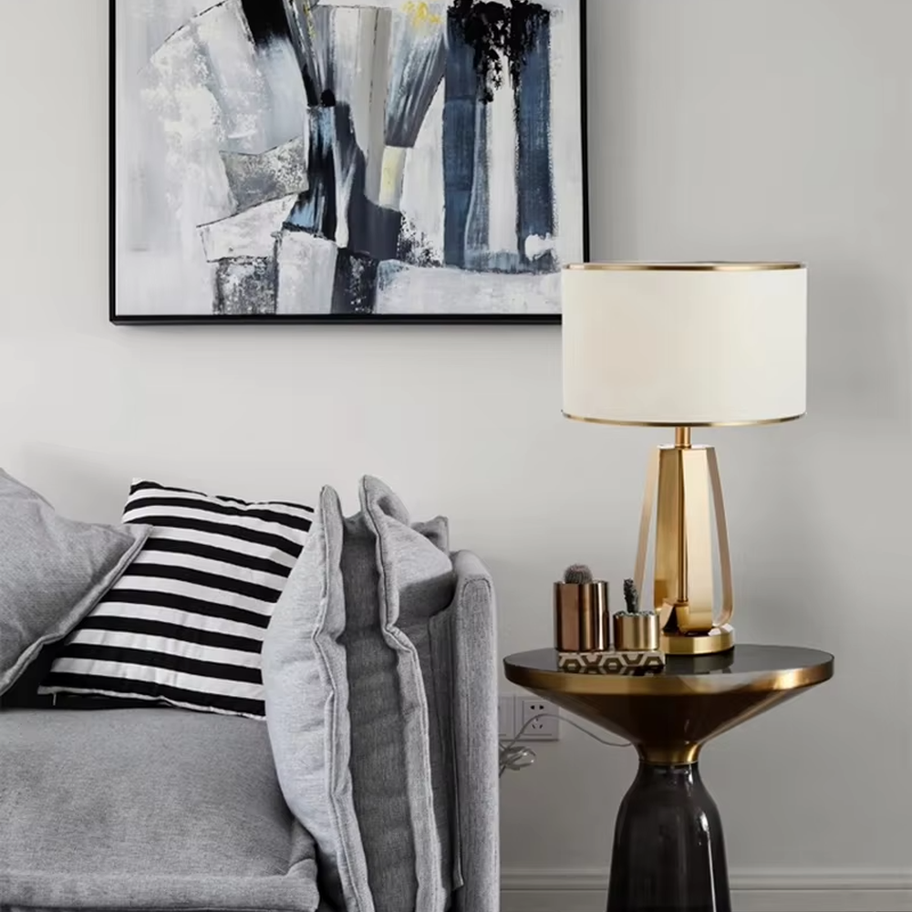 Light luxury golden geometric stand table lamp, beige fabric lampshade + golden decorative ring, soft lighting, creating a high-end elegant atmosphere.