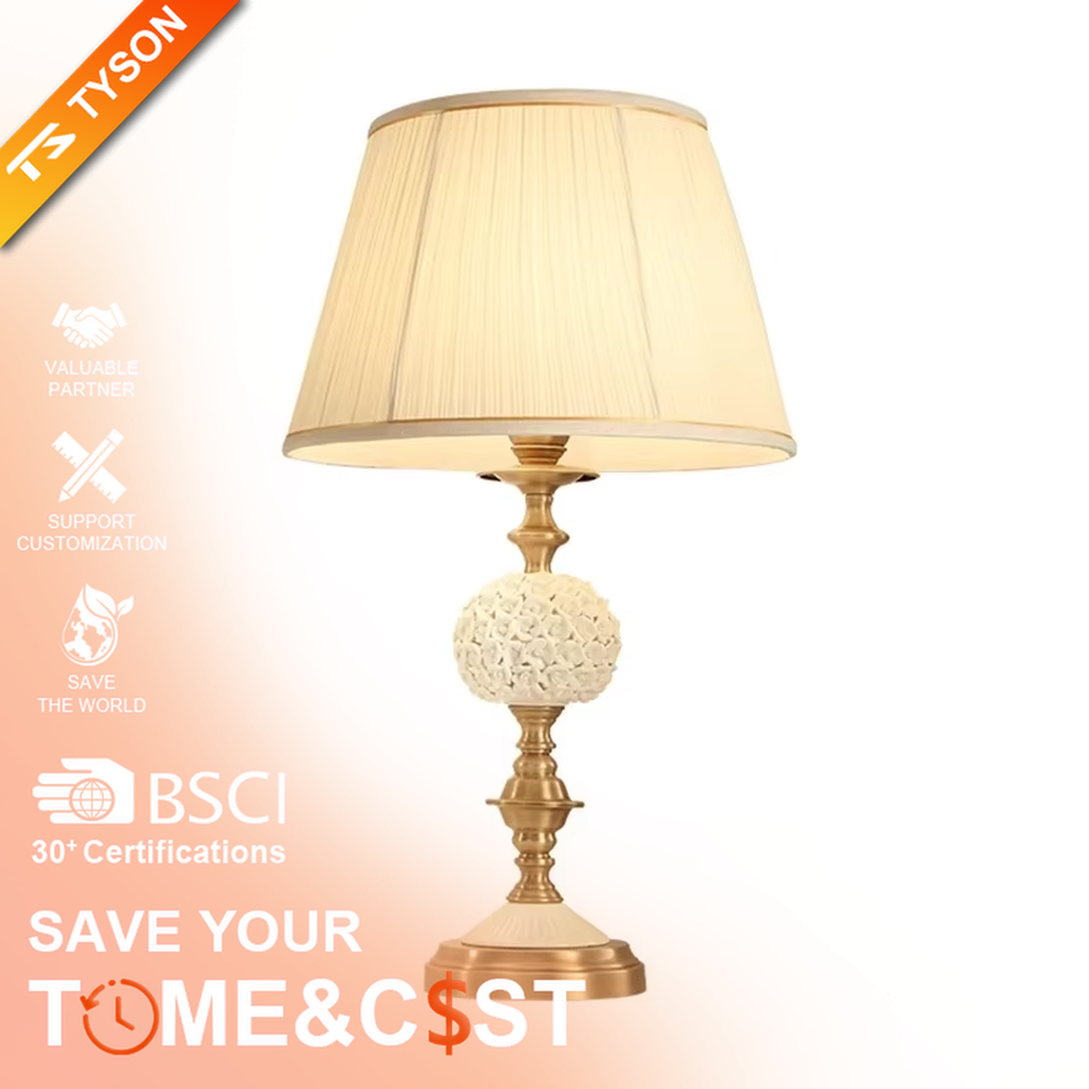 This is a European light luxury pleated fabric table lamp, with golden metal paired with a white carved spherical base, a beige pleated lampshade, soft and warm lighting, creating an elegant light luxury atmosphere.