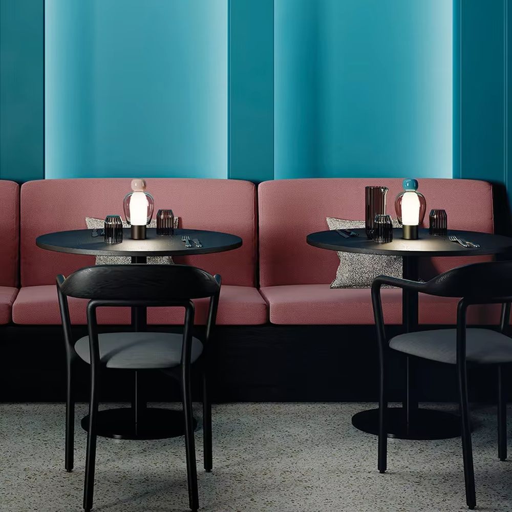 This is an artistic doll-style glass and metal table lamp, with a transparent glass shell, pink top, and metal base. Its unique shape is like an artistic doll, featuring a strong modern artistic sense. It is used for local desktop lighting and decoration, creating an artistic and modern atmosphere. Suitable for art exhibition halls, corners of modern home studies, designer studios and other places.