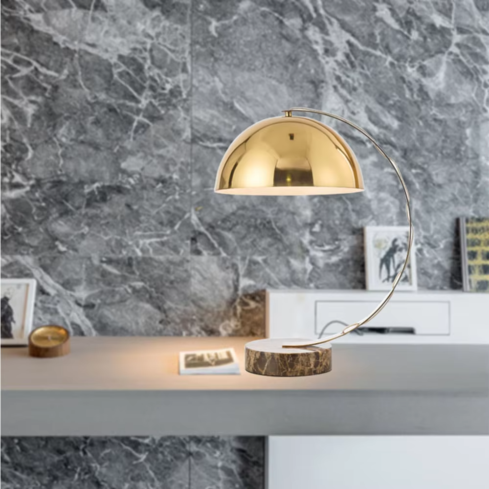 Light luxury golden curved hemisphere table lamp, marble-patterned round base, soft and warm lighting, creating a high-end elegant space atmosphere.