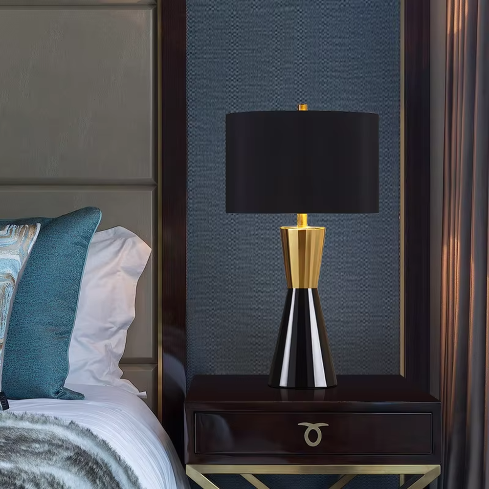 This is a light luxury black-gold cone table lamp, with a black cone base paired with golden decorations, a beige cylindrical lampshade with golden trim, soft and warm lighting, creating an elegant light luxury atmosphere.