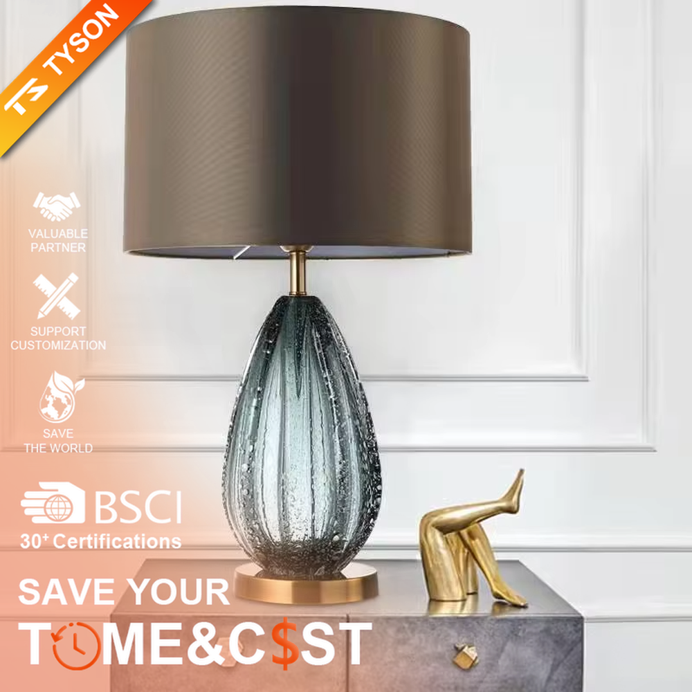 Light luxury dark brown fabric lampshade teardrop-textured table lamp, black-gray textured base + golden base, soft lighting, creating a high-end elegant atmosphere.