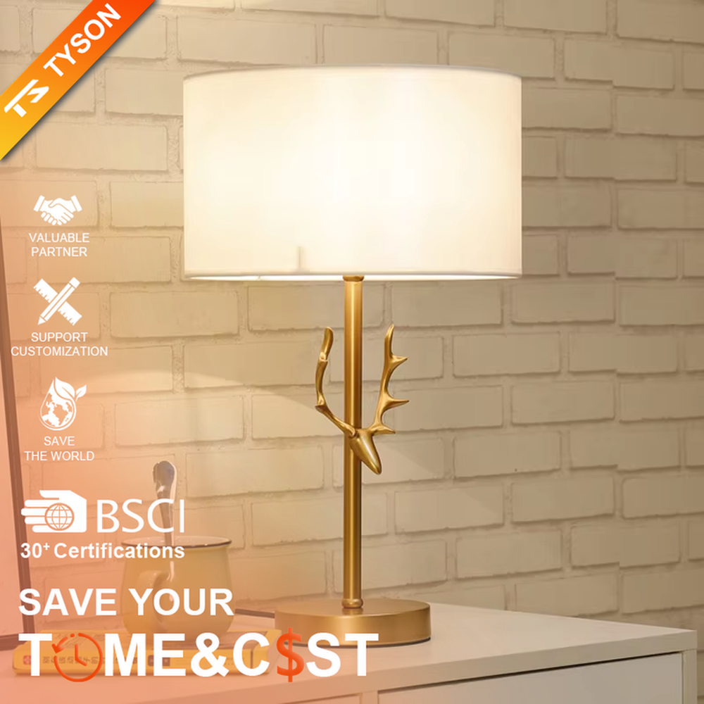 Light luxury golden antler-shaped table lamp, white cylindrical fabric lampshade + golden base, soft and warm lighting, creating a natural elegant atmosphere.
