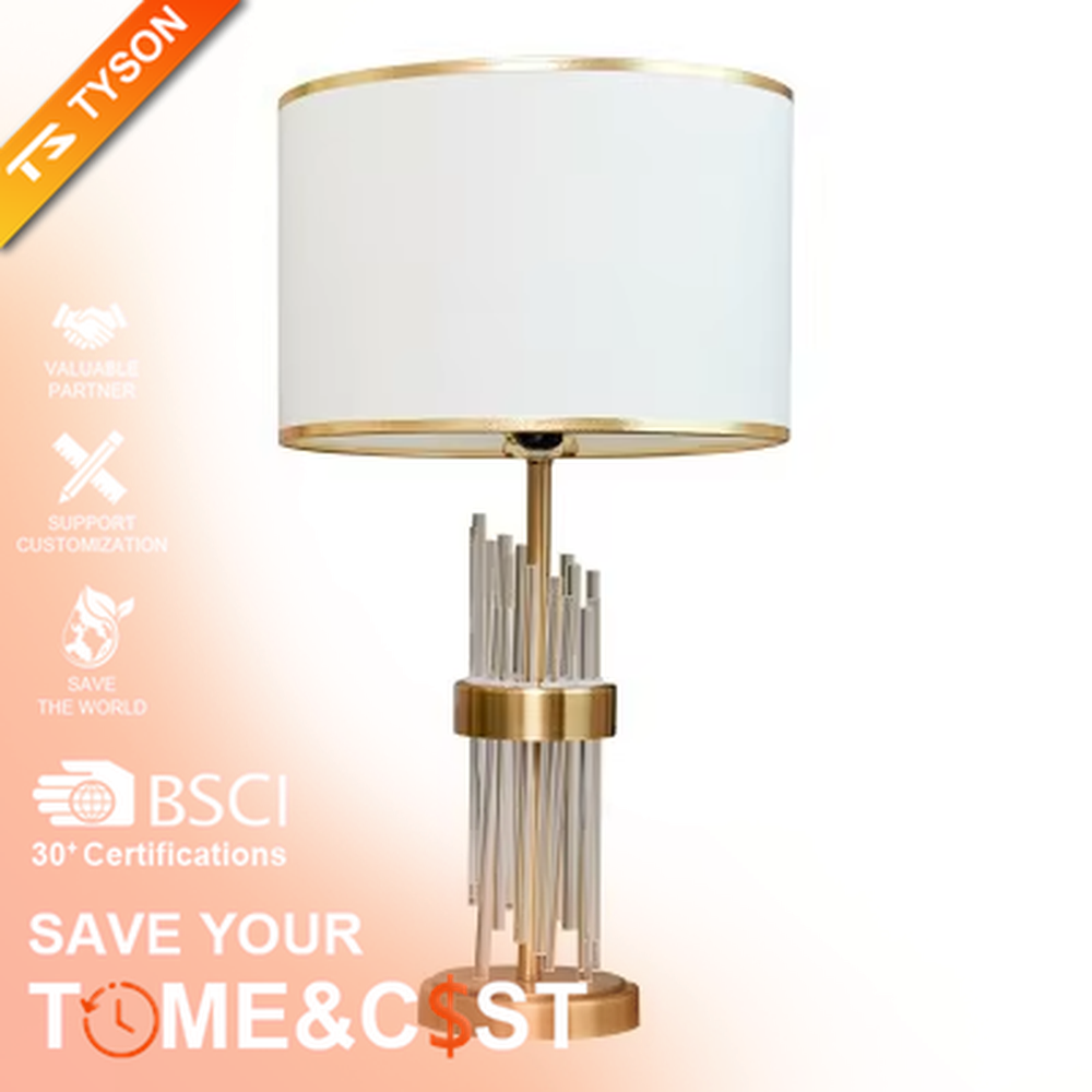 This is a light luxury crystal-metal splicing table lamp, with an off-white fabric lampshade edged with gold trim, a lamp post made of transparent crystal strips and gold metal, and a gold metal base, featuring both decorative and lighting functions, ideal for high-end indoor scenarios such as bedroom nightstands and living room side tables.