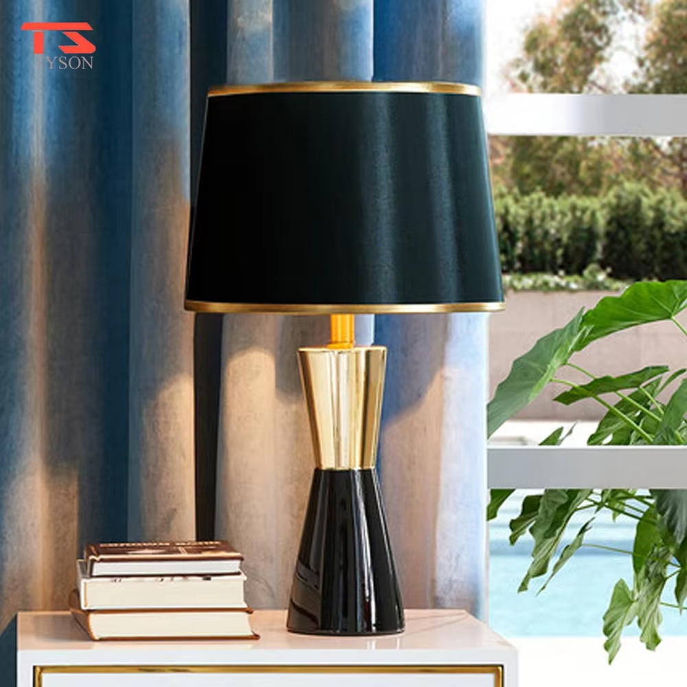 This is a light luxury black-gold table lamp, with a black fabric lampshade edged with gold trim, and a cone-shaped base with a black-gold color block design, featuring both decorative and lighting functions, ideal for high-end indoor scenarios such as bedroom nightstands and living room side tables.