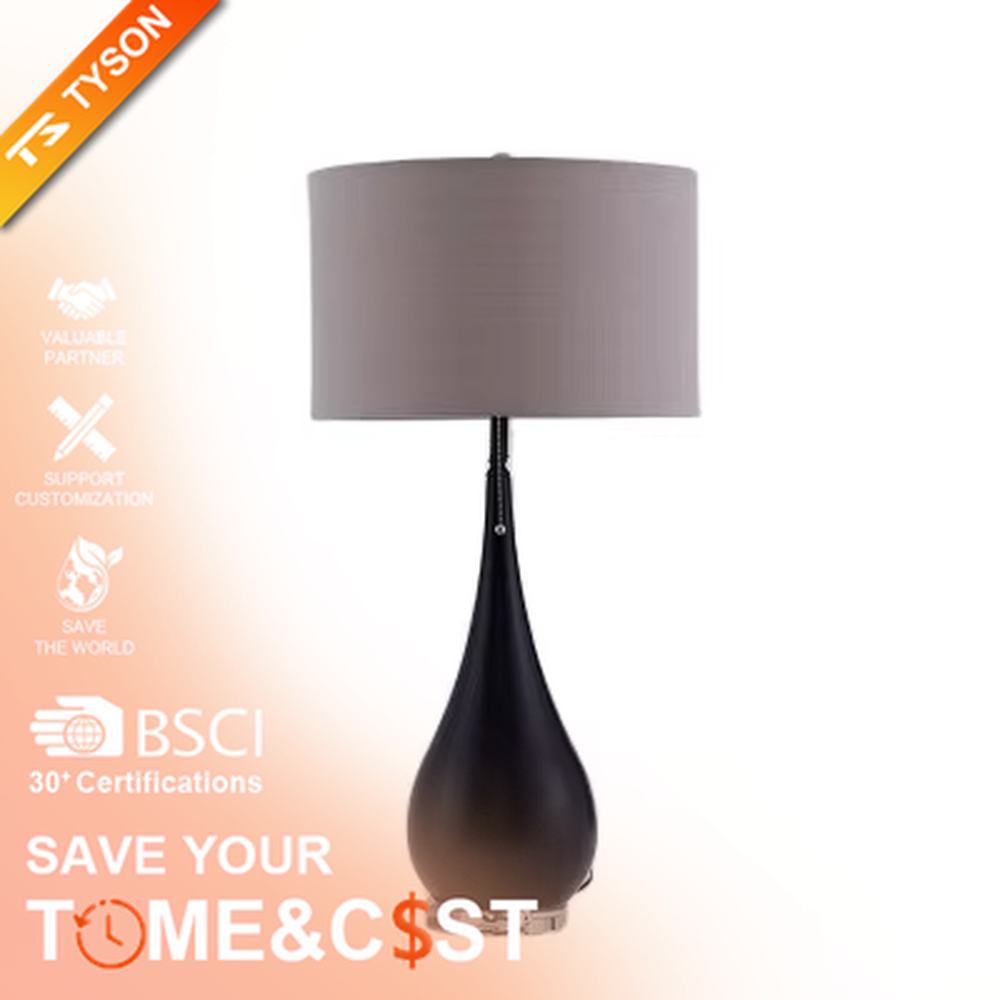 This is a pastoral-style floral fabric table lamp, with an off-white lampshade printed with blue and black floral patterns, paired with a black matte teardrop-shaped base and transparent crystal feet, featuring both decorative and lighting functions, ideal for warm indoor scenarios such as bedroom nightstands and living room side tables.