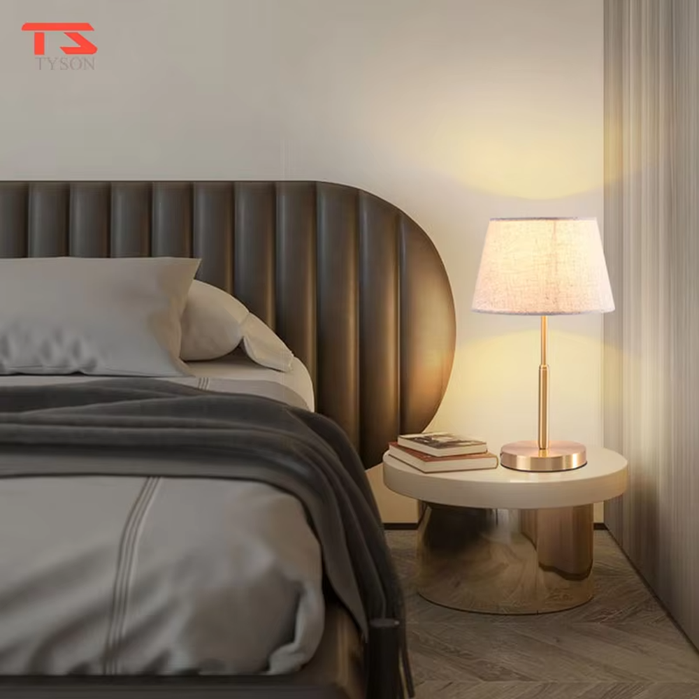 Modern light luxury golden metal pole linen texture fabric shade round base table lamp, warm light effect, creating an elegant minimalist home atmosphere.