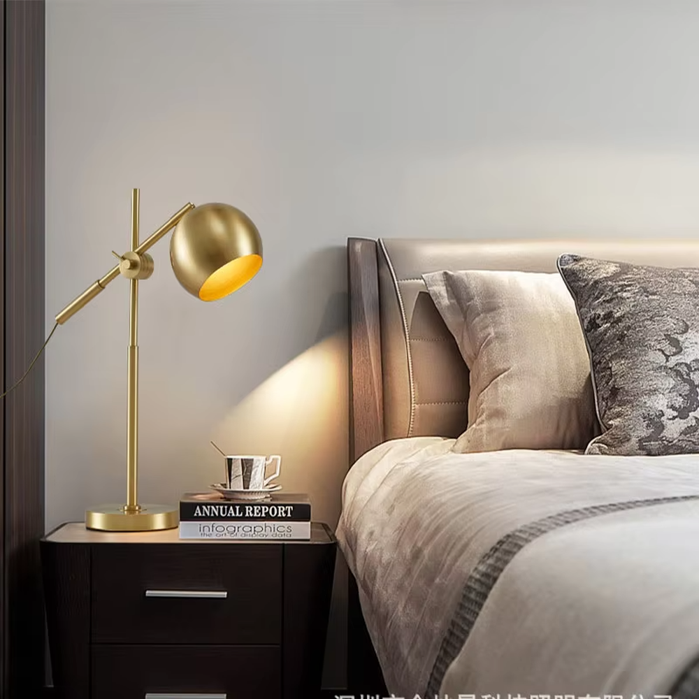 This is a modern light luxury style gold metal table lamp, featuring a spherical lampshade paired with an adjustable long arm and a stable base, which has both lighting and decorative functions, suitable for bedroom nightstands, study desks, hotel guest rooms and other spaces.