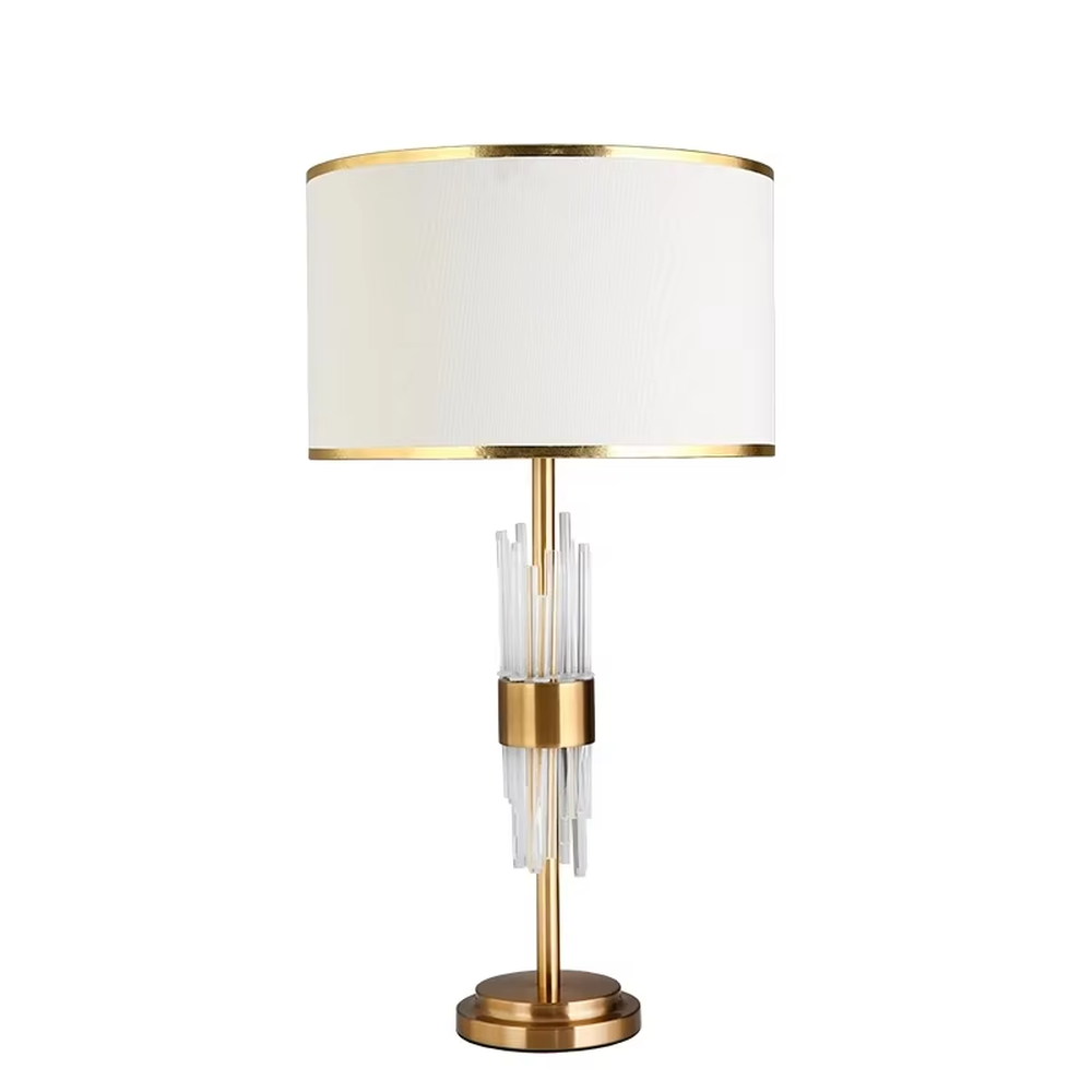 Light luxury style crystal and metal segmented table lamp, featuring transparent crystal columns paired with gold metal accessories, and an off-white fabric lampshade with a gold trim at the bottom. It emits soft and warm light, combining decorativeness and practicality, suitable for lighting and decoration in spaces such as bedroom nightstands, living room side tables, and hotel guest rooms.