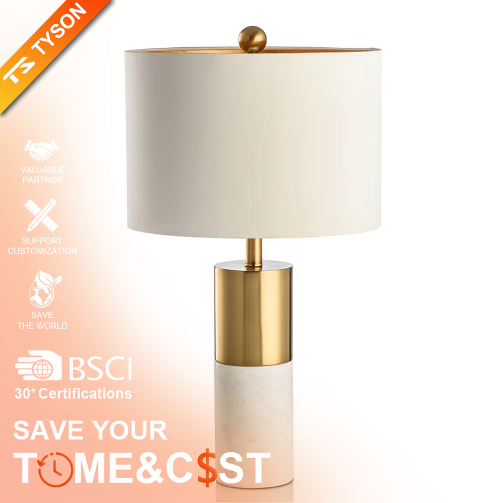 This is a light luxury marble-metal splicing table lamp, with a white fabric lampshade paired with a base made of gold metal and gray marble, accented with an orange decorative ball on top, featuring both decorative and lighting functions, ideal for high-end indoor scenarios such as bedroom nightstands and living room side tables.