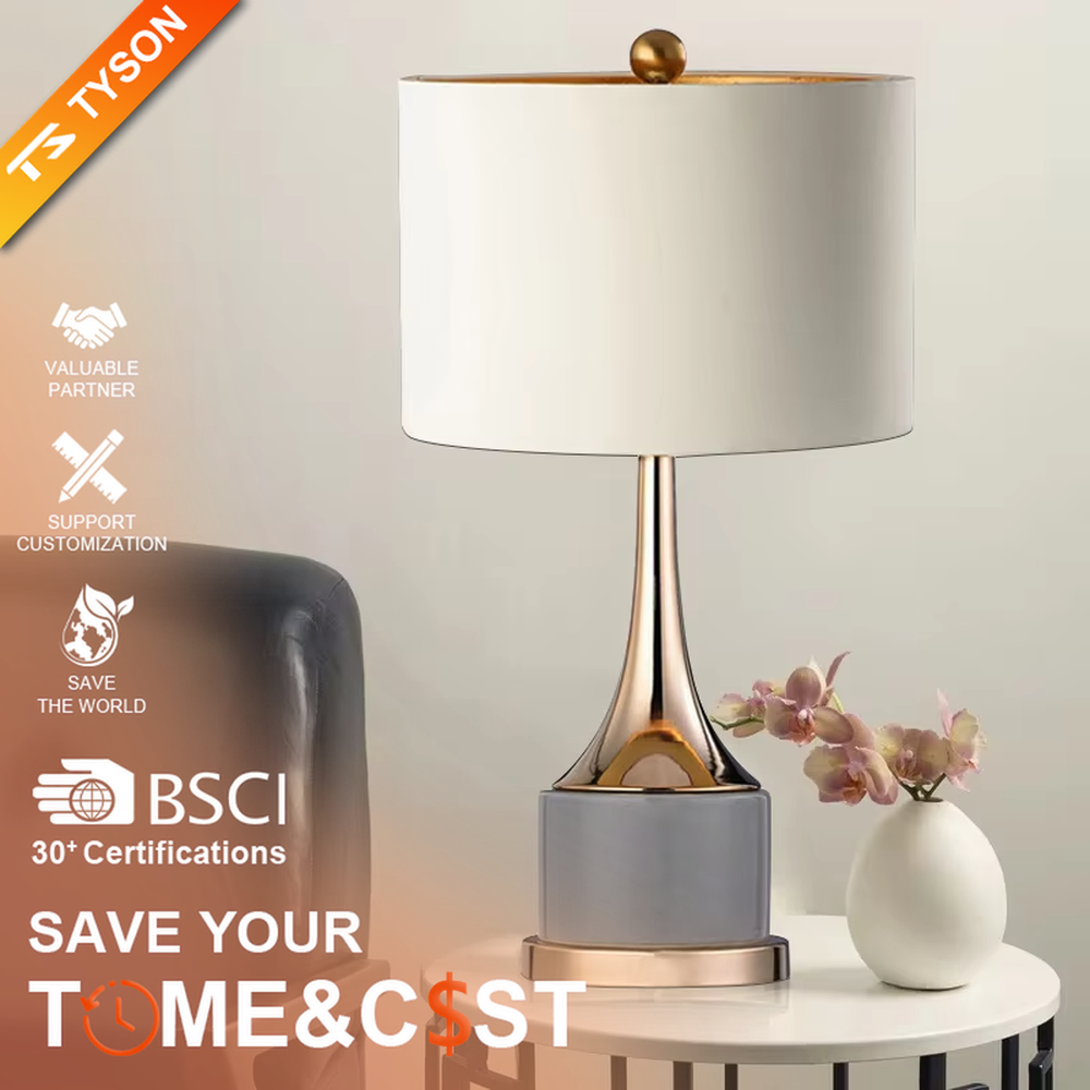 Light luxury gray-gold fabric lampshade metal base table lamp (gray fabric shade + gold pole + gray stone-pattern base), warm light effect, creating an exquisite and elegant atmosphere.