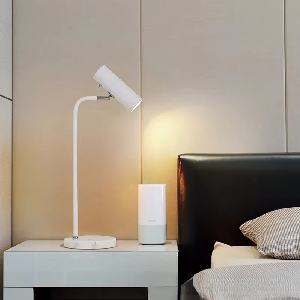 Minimalist white rod marble table lamp (white curved rod + adjustable lamp head + marble base), warm light effect, creating a simple and high-end home atmosphere.